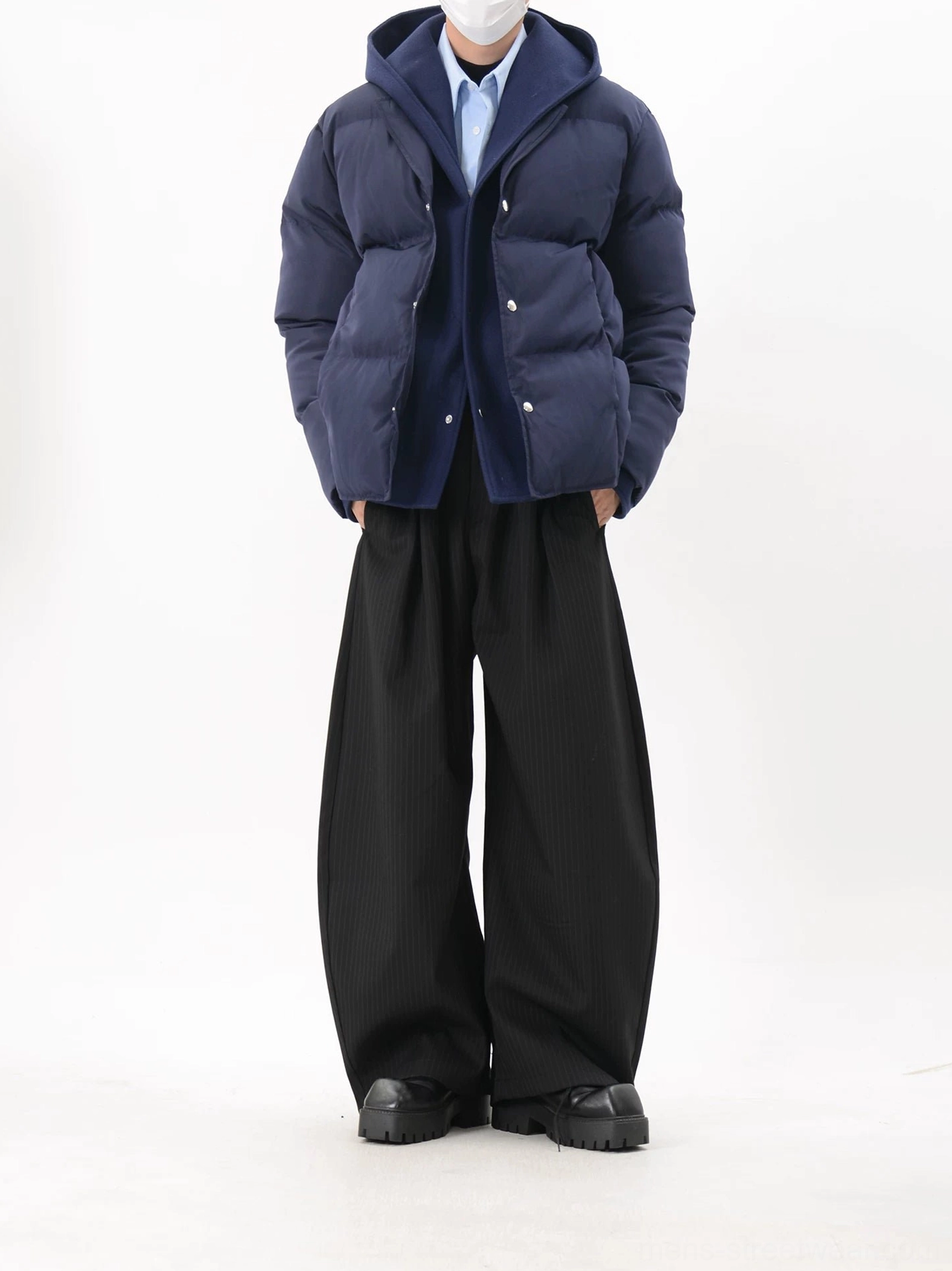 Navy blue hooded snap-button puffer jacket showing clean cropped fit and minimal quilted construction