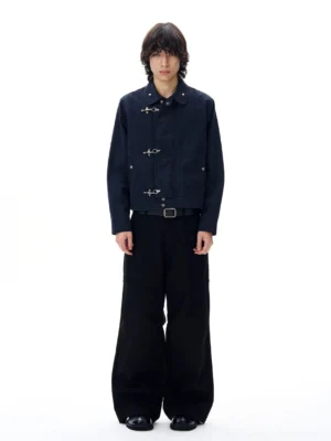 Navy blue metal toggle cropped utility jacket front view styled with black wide-leg trousers in a minimalist studio