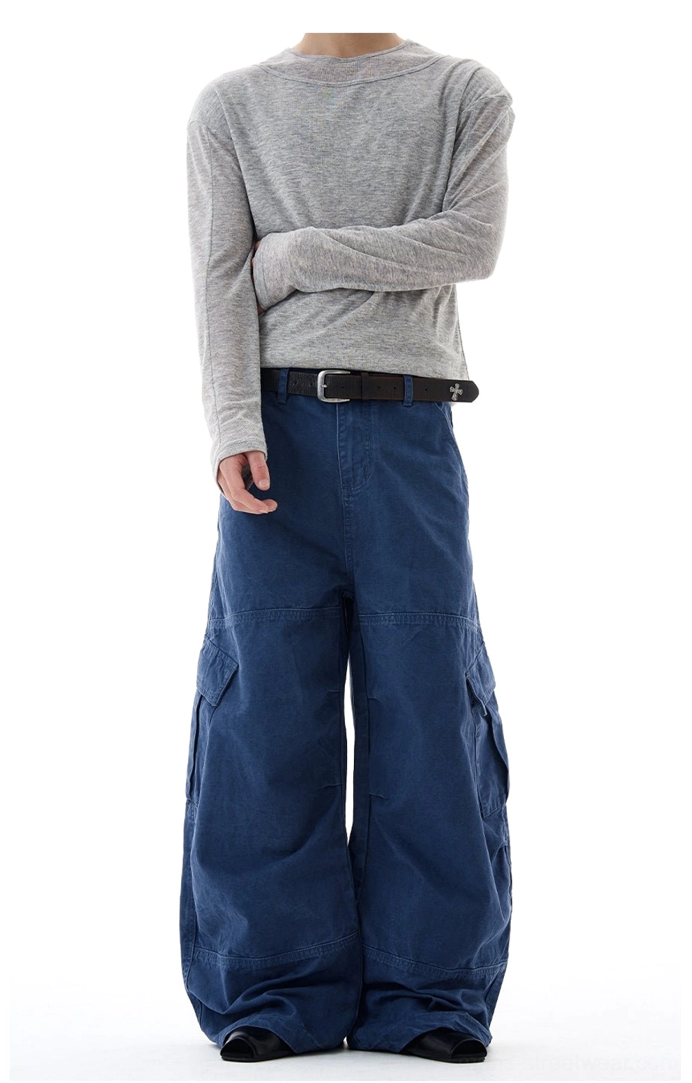Navy blue oversized cargo trousers shown from the front with a relaxed wide-leg cut, side utility pockets, and cotton construction