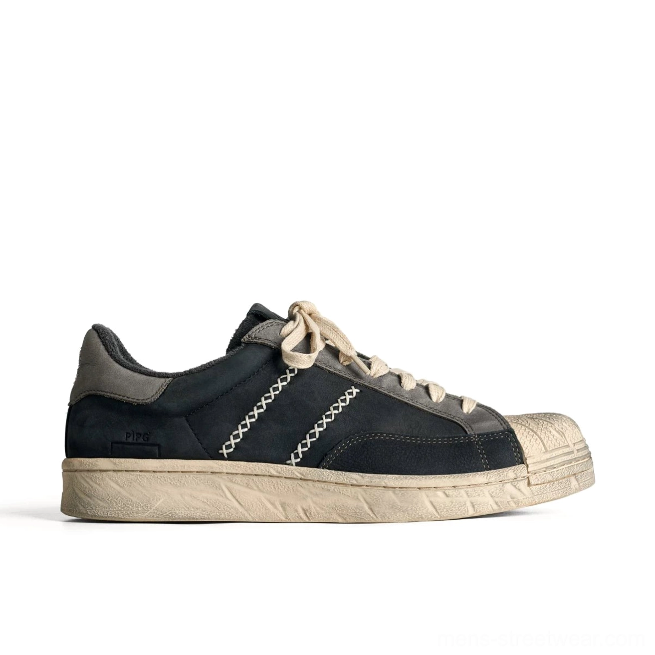 Dark navy and charcoal grey low-top leather sneaker with cream contrast stitching and vintage rubber sole