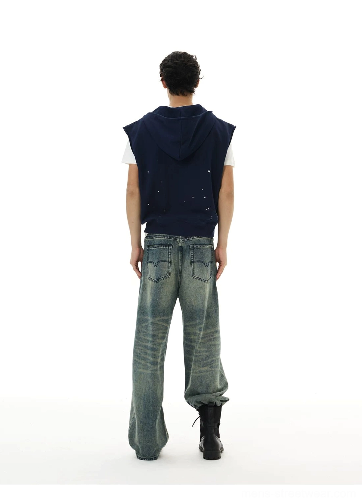 Rear view of navy splatter graphic sleeveless zip hoodie vest with hood up in a Korean streetwear outfit