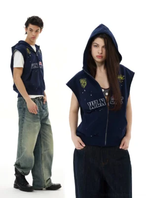 Navy collegiate crest sleeveless zip hoodie vest shown on male and female models in layered streetwear outfits