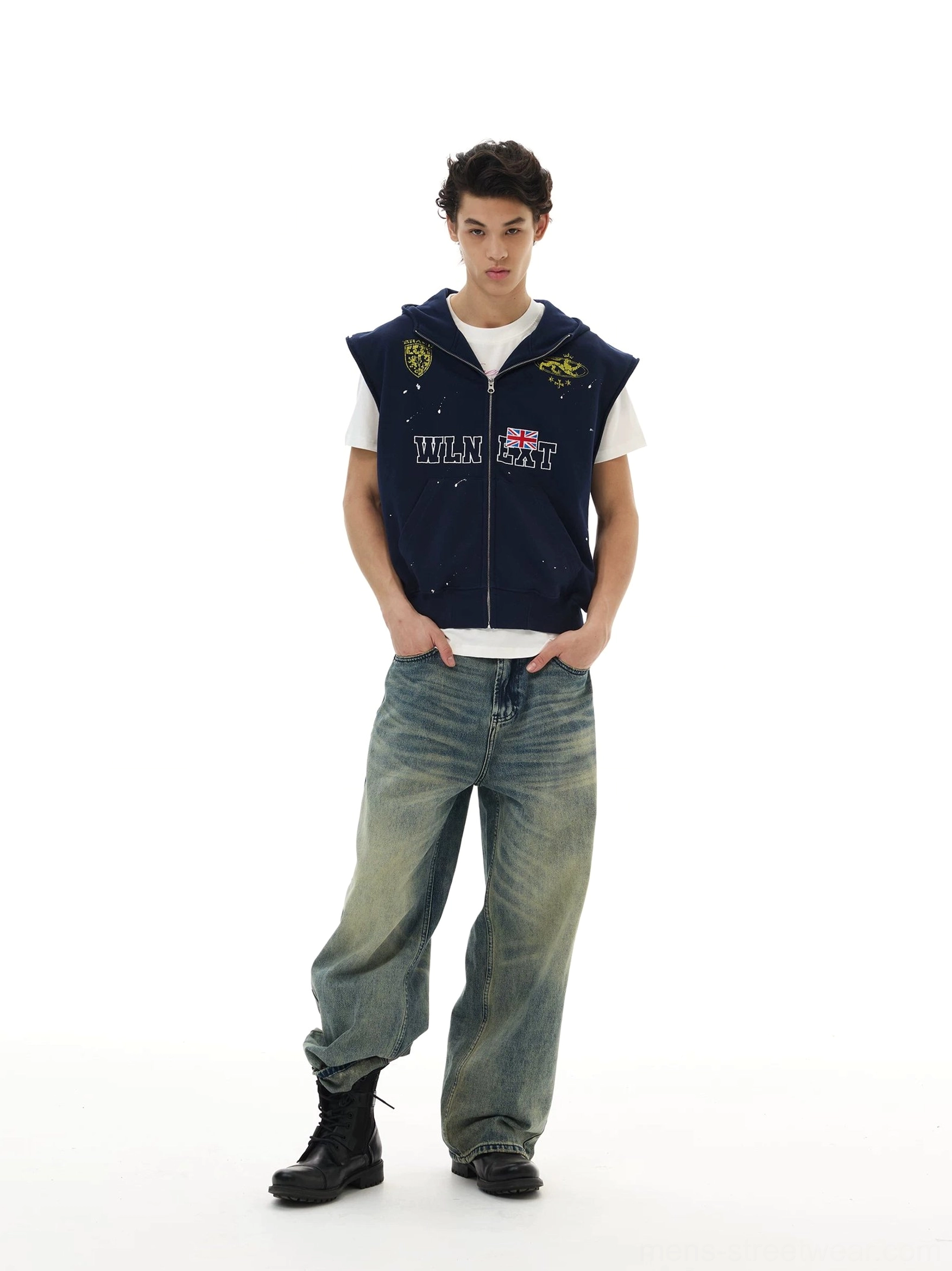 Navy sleeveless zip hoodie vest with collegiate lettering crest graphics and paint splatter details on male model