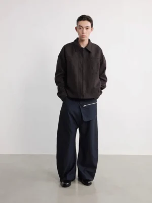 Full front view of men's navy detachable zipper pouch wide-leg trousers in a minimalist white studio