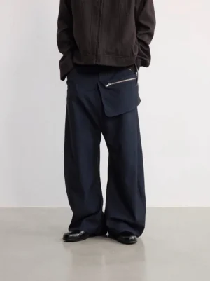 Rear view of navy detachable zipper pouch wide-leg trousers styled with a dark brown zip-up jacket and leather dress shoes