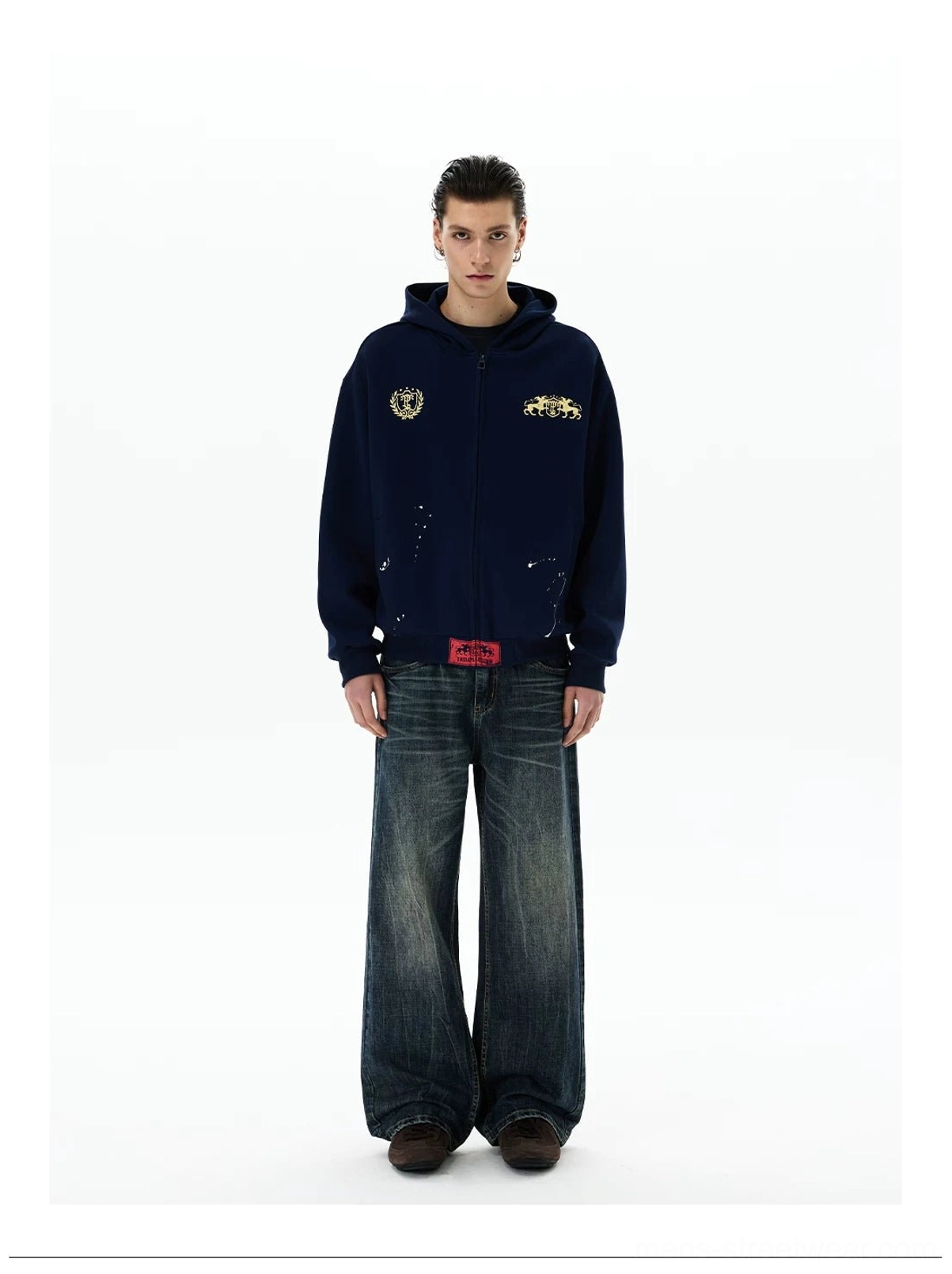 Oversized navy heraldic crest zip-up hoodie front view with contrast red hem tab