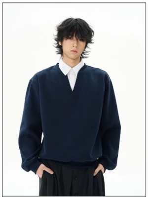Front view of a navy notch-neck oversized sweatshirt with layered striped collar, drop shoulders, ribbed cuffs, and relaxed Korean streetwear fit