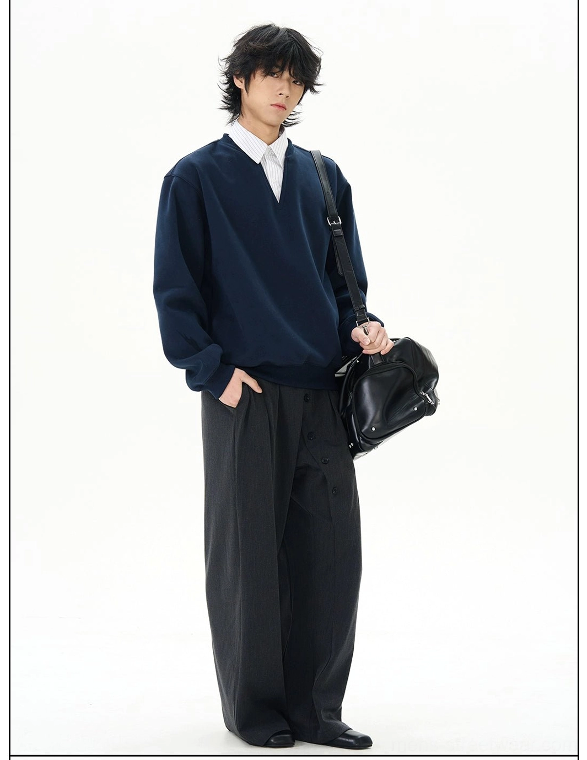 Side three-quarter view showing the relaxed oversized silhouette and drop-shoulder construction of a navy notch-neck sweatshirt