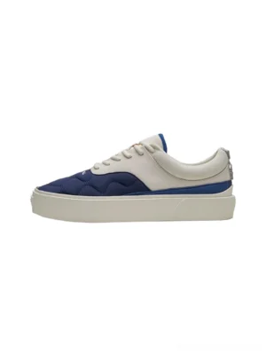 Navy and off-white quilted colorblock platform sneakers shown from a side angle with padded toe cap and thick rubber sole