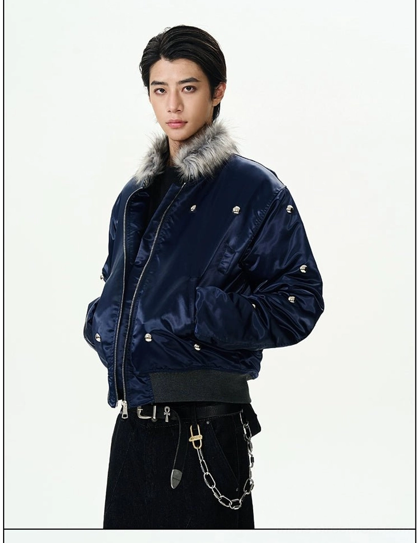 Left three-quarter view of a navy satin bomber jacket with grey faux fur collar chain wallet accessory and ribbed hem