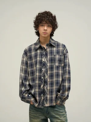 Male model wearing navy beige tartan oversized button-up shirt with chest pocket and vintage denim front view
