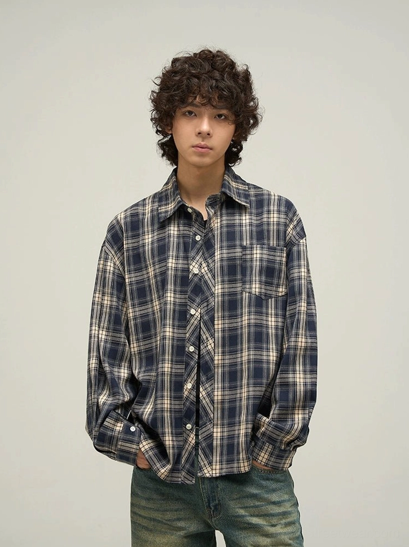 Male model wearing navy beige tartan oversized button-up shirt with chest pocket and vintage denim front view