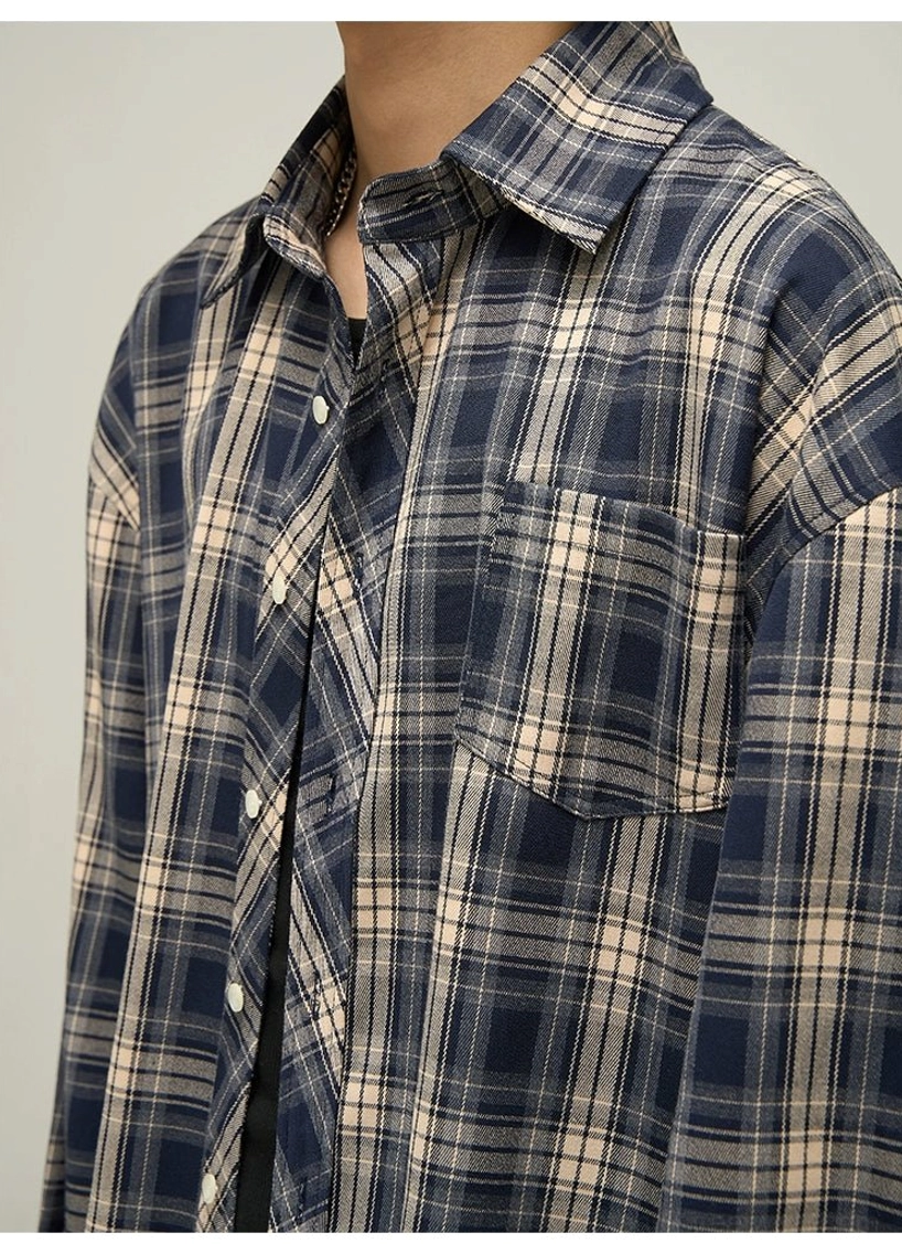 Close-up detail of navy tartan woven shirt fabric spread collar chest pocket and full button front placket