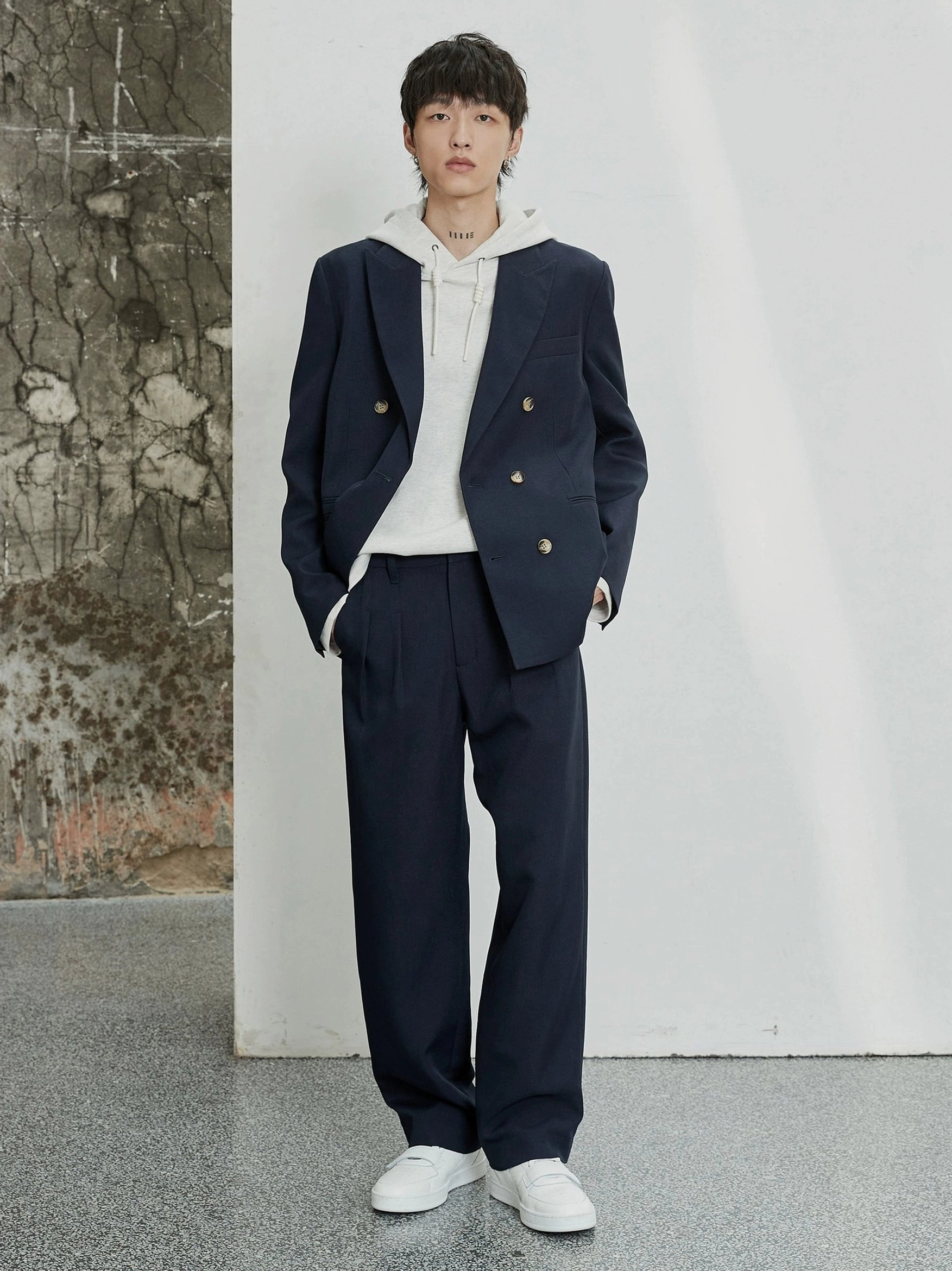 Navy wide-leg tailored dress pants worn with a double-breasted blazer and hoodie