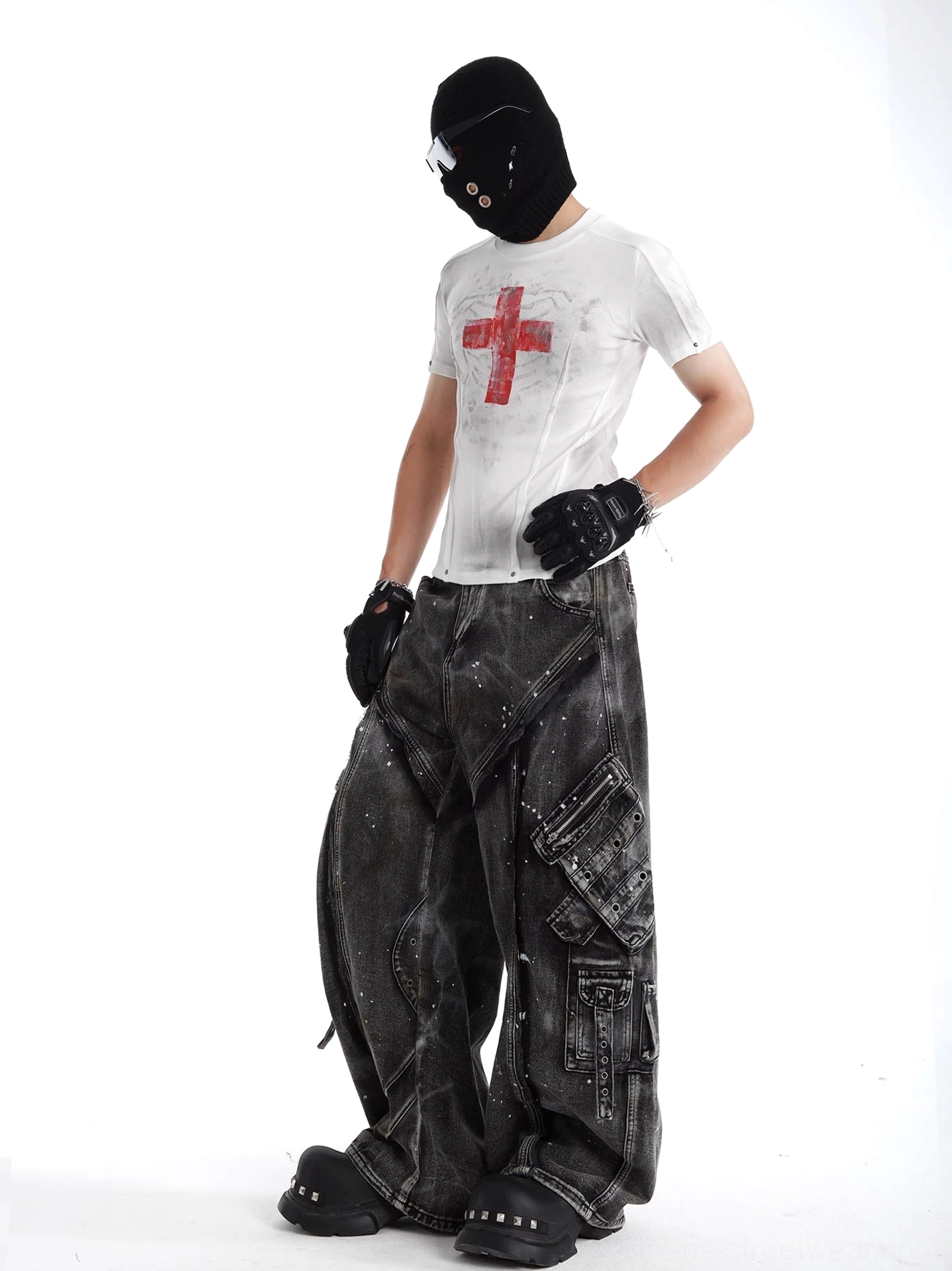 Three-quarter side view of oversized gray cargo denim jeans with rivet accents, layered pockets, and wide baggy legs