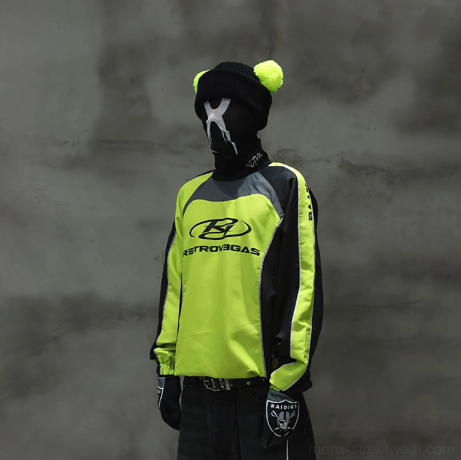 Neon lime green and black racing jersey styled with dark jeans in a contemporary urban outfit