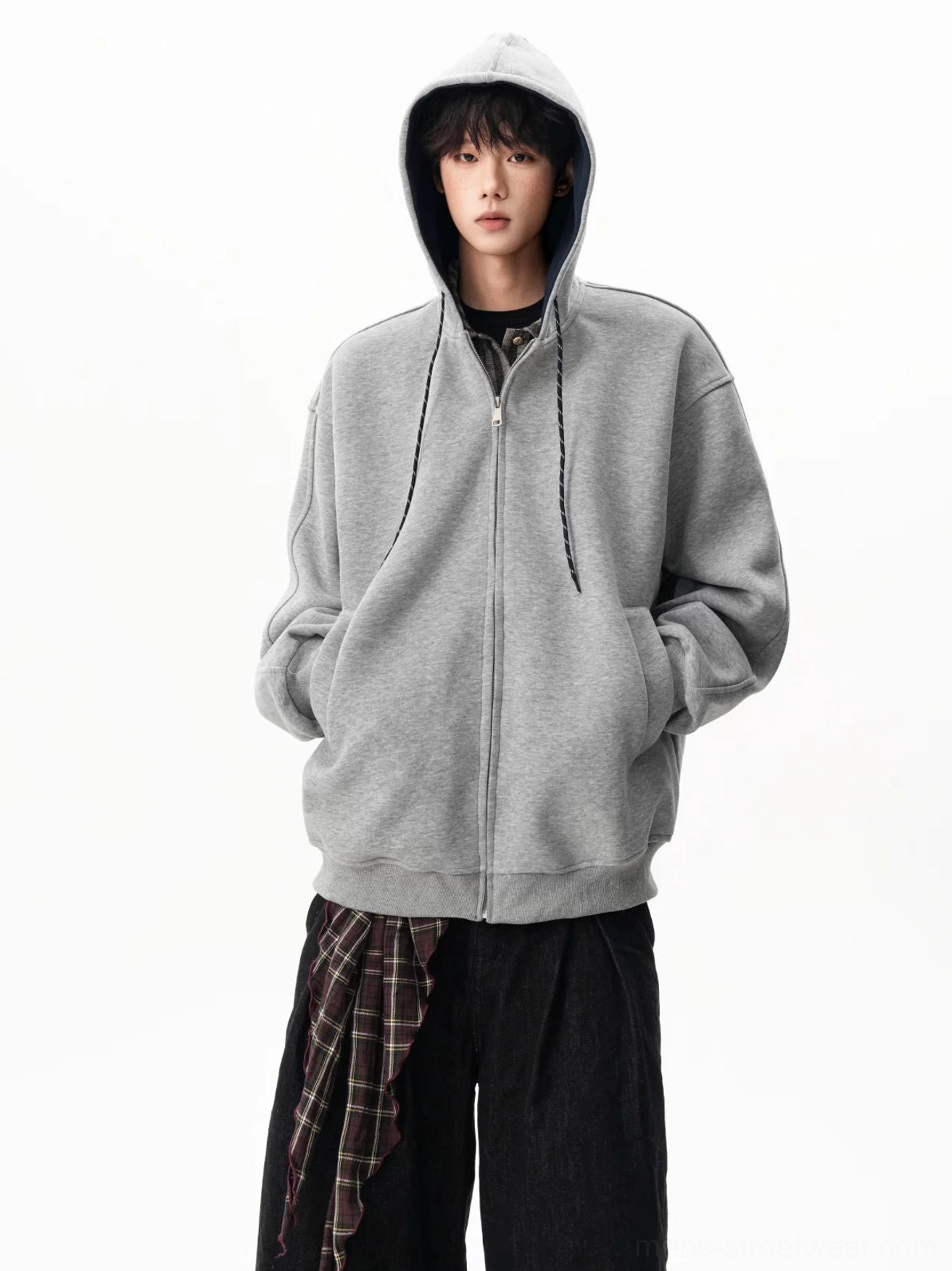 Neutral gray oversized fleece hoodie with adjustable drawstrings and casual hands-in-pockets styling