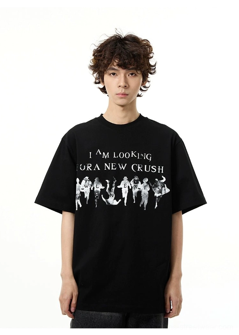 Front view of a male model wearing a black oversized New Crush graphic streetwear t-shirt with white typography