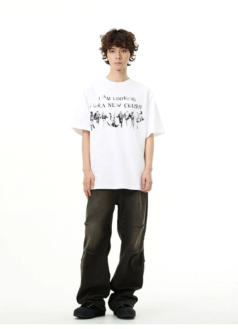 Male model wearing the white New Crush graphic oversized streetwear t-shirt with dark cargo pants