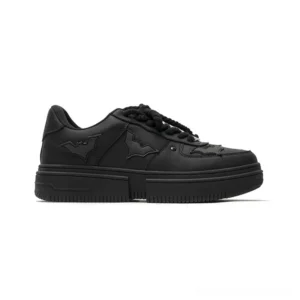 Side view of black Nightwing bat crest platform streetwear sneakers with matte PU upper, rope laces, and chunky rubber sole