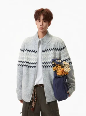 Heather gray Nordic Fair Isle zip-up knit cardigan worn in a front three-quarter view with navy and cream zigzag jacquard pattern