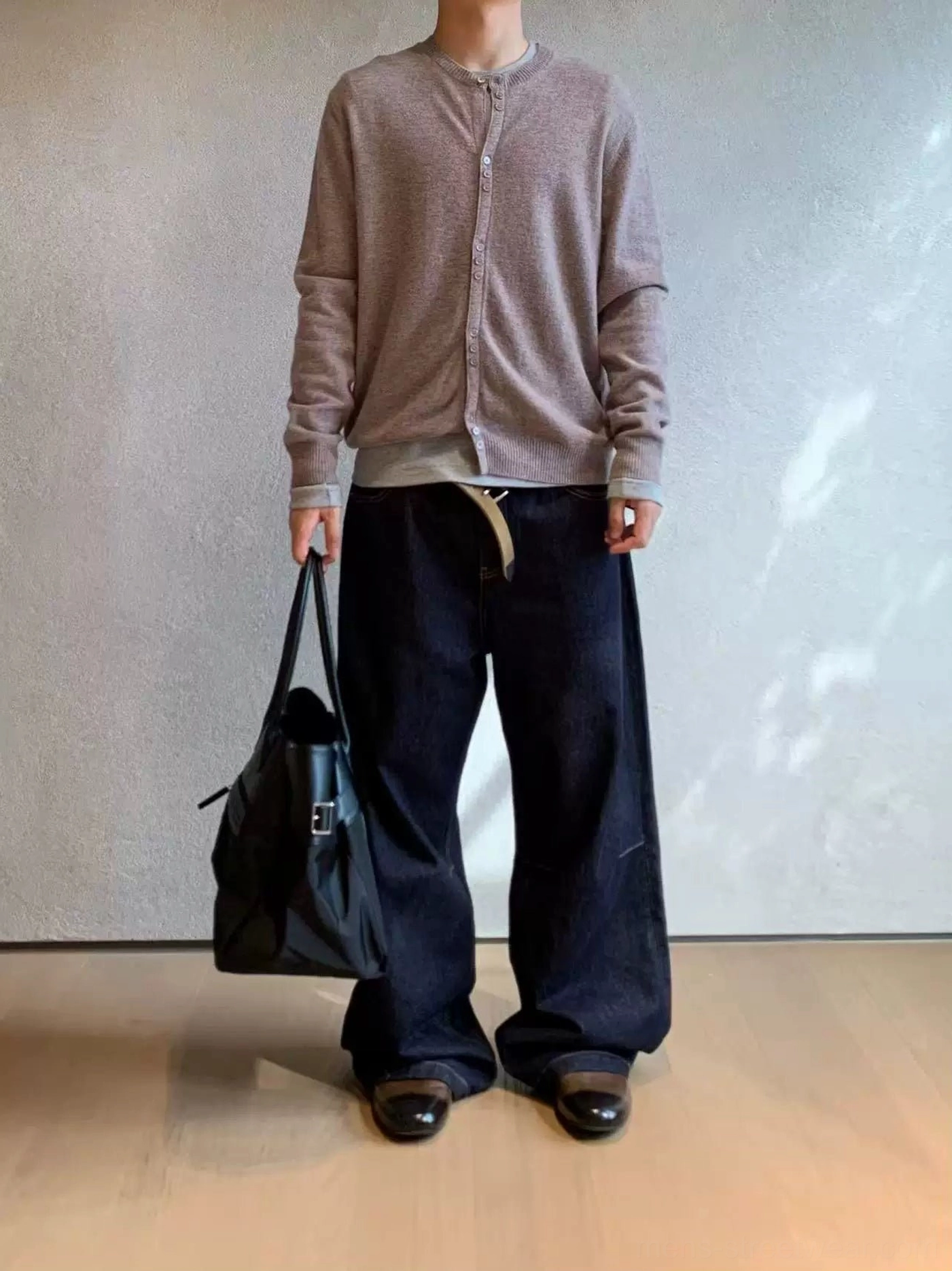 Heather oatmeal brown henley knit cardigan styled with wide-leg drawstring trousers and a black leather tote bag
