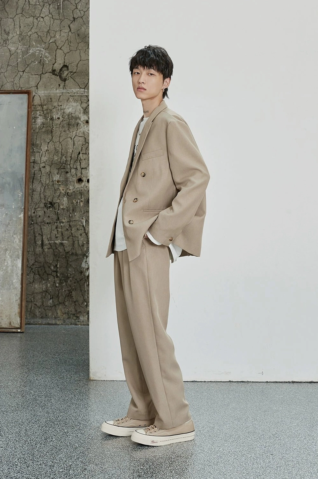 Oatmeal relaxed dress pants shown from the side with a clean straight-leg Korean streetwear silhouette