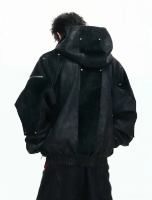 Back view of black armored streetwear hoodie jacket with fleece back panel rivet details and ribbed hem