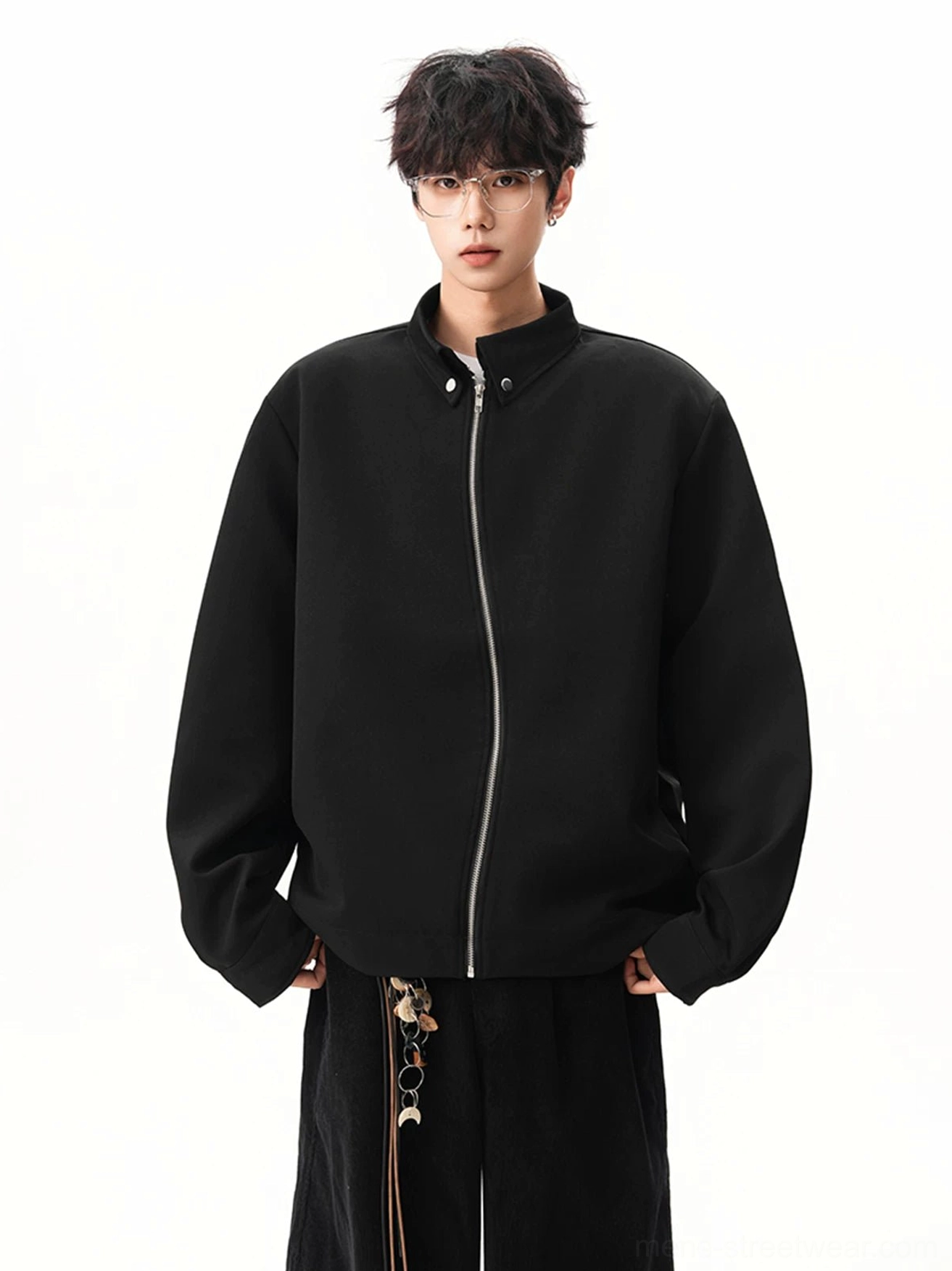 Front view of black minimalist stand collar zip jacket fully zipped with silver hardware and relaxed dropped shoulder fit