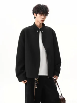 Black obsidian stand collar zip jacket worn by male model in a relaxed Seoul streetwear outfit front three quarter view