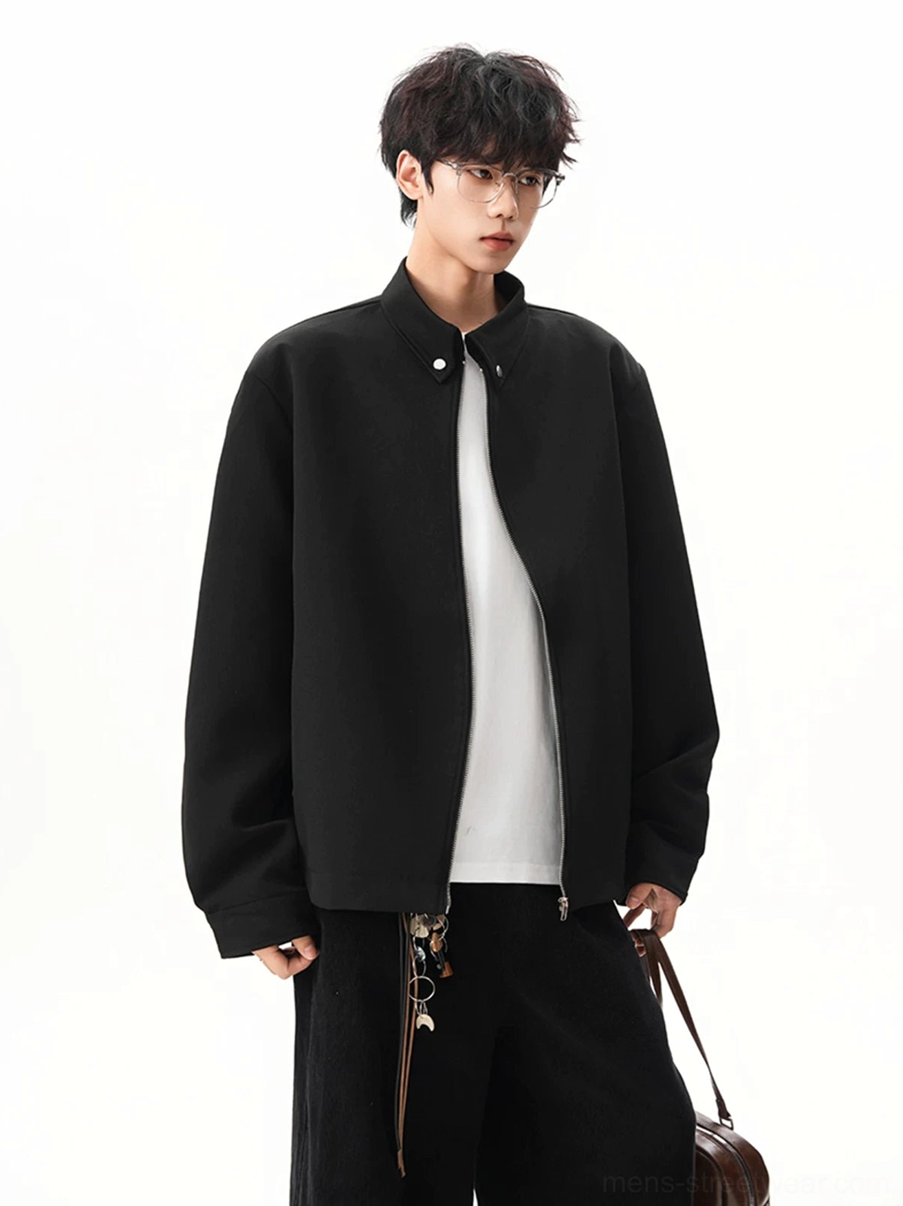 Black obsidian stand collar zip jacket worn by male model in a relaxed Seoul streetwear outfit front three quarter view