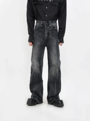 Front view of vintage washed black wide-leg jeans with structured rise, classic five-pocket design, faded denim finish, and chunky streetwear shoes