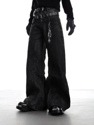 Black Obsidian Eclipse ultra-wide leg denim pants shown from the front on a model in punk streetwear styling with a dramatic puddled hem