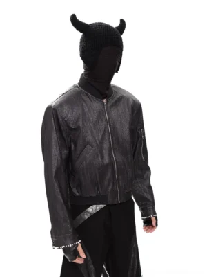 Obsidian Flux distressed black PU cropped bomber jacket shown in three-quarter side view with ribbed trims, sleeve zip pocket, and textured streetwear finish
