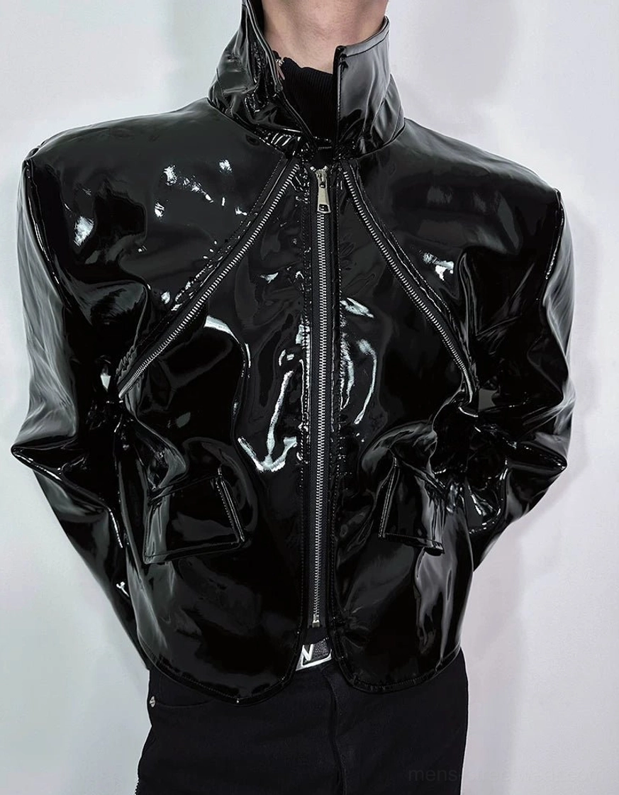 Upper torso close-up of black patent-look PU cropped jacket with high collar central zipper and wide shoulders