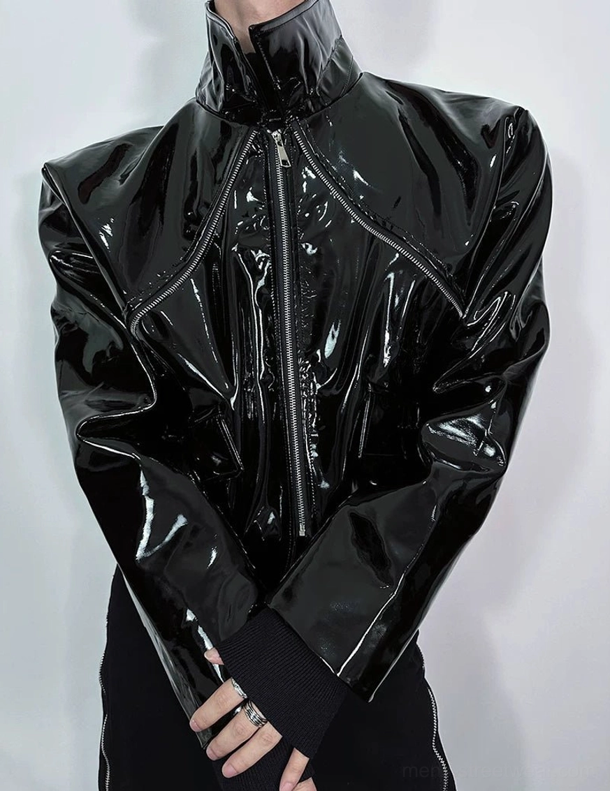 Close-up of black glossy cropped moto jacket with tall stand collar structured shoulders and metal front zipper