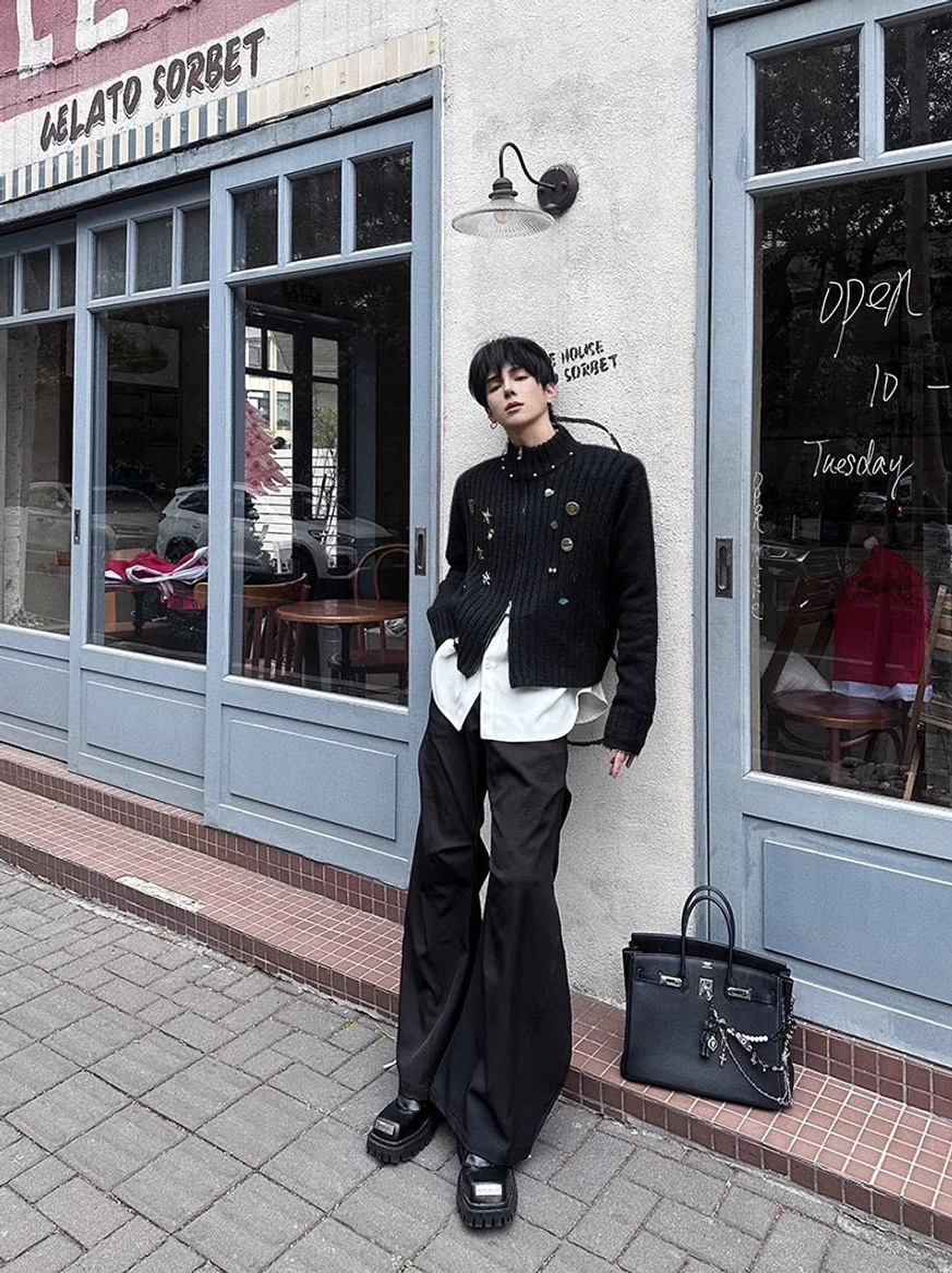 Black hyperwide tailored flare trousers styled on a city sidewalk with a layered dark outfit, chunky leather loafers, and modern Korean street fashion appeal
