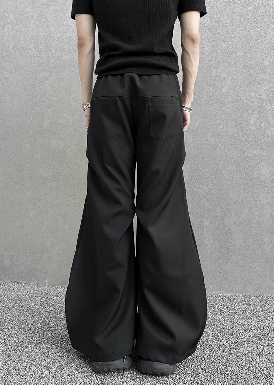 Obsidian black hyperwide flare cargo pants with a sculpted long-leg silhouette, clean seams, and modern avant-garde streetwear design