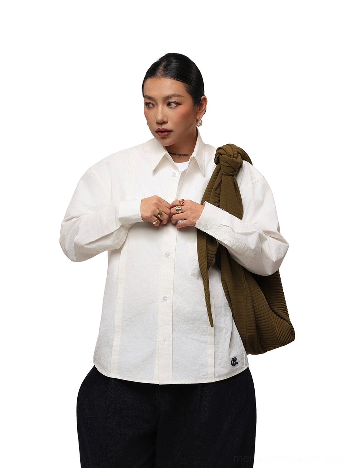 Female model wearing off-white cotton poplin overshirt with black wide-leg trousers in minimalist Seoul streetwear outfit
