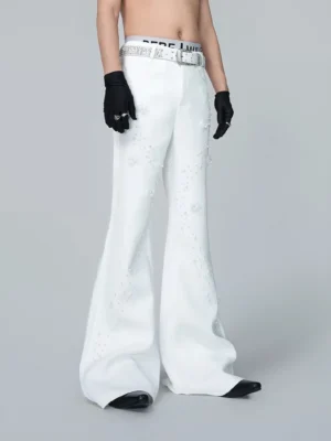 Straight front view of high-waisted off-white Korean streetwear flare trousers with pearl trails floral embellishments and decorative belt