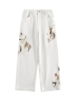 Front flat view of off-white lace panel wide-leg denim jeans for men with dark brown black patterned appliqué details