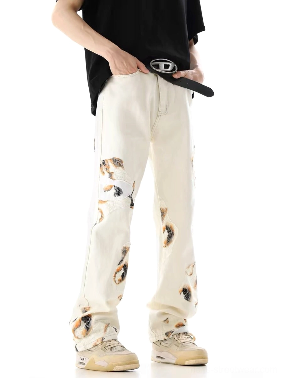 Male model wearing off-white lace panel wide-leg denim jeans with black t-shirt and casual sneakers front view