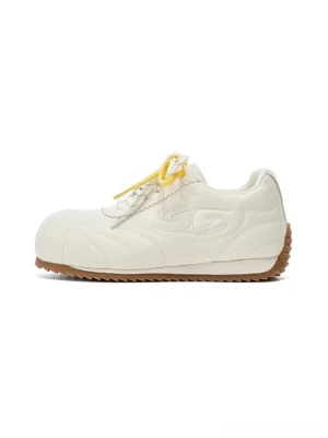 Off-white low-profile retro streetwear trainers with layered lacing, embossed side detailing, and gum rubber outsole shown in side view