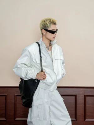 Off white stand collar oversized bomber jacket three quarter side view with flap chest pockets and black chain shoulder bag