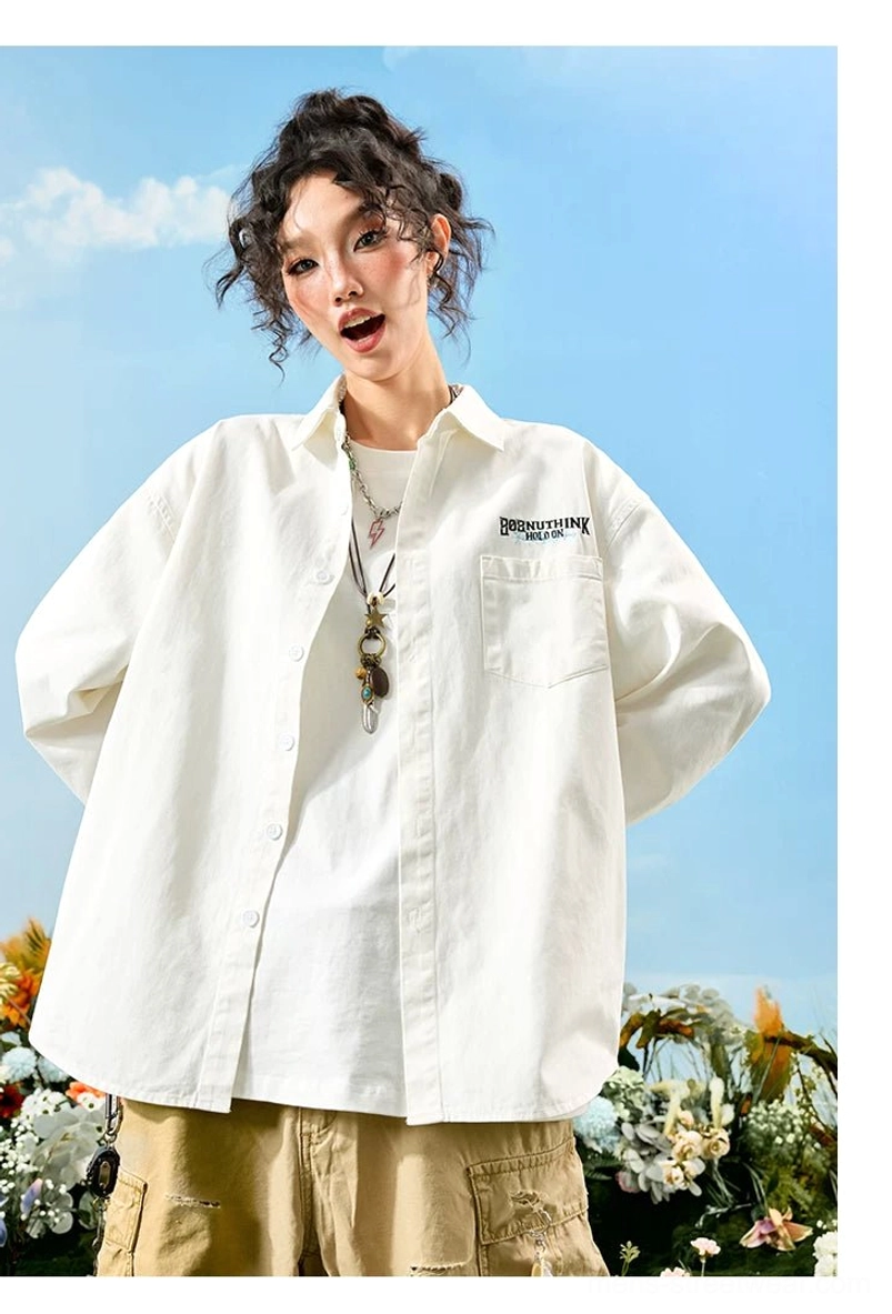Female model wearing an off-white oversized embroidered button-up shirt with chest pocket, front logo, layered necklace, and white tee