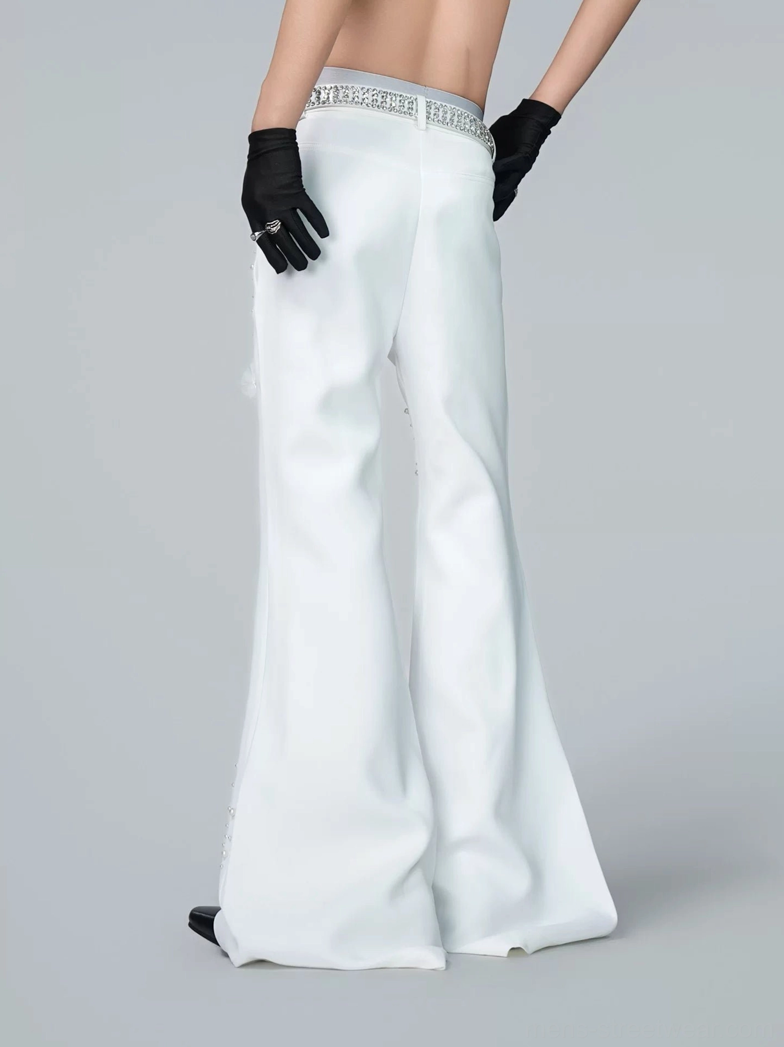 Back view of off-white oversized wide-leg flare trousers featuring a clean structured rear silhouette and matching embellished belt