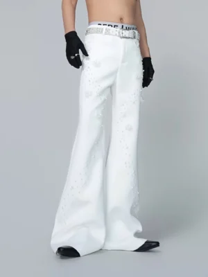 Front three-quarter view of off-white pearl embellished wide flare trousers with 3D floral appliques and matching rhinestone-style belt