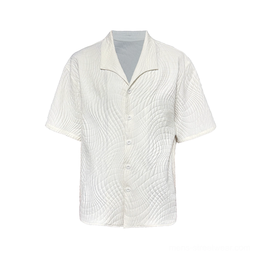Off-white quilted camp collar shirt flat lay showing wavy jacquard texture short sleeves and full button placket