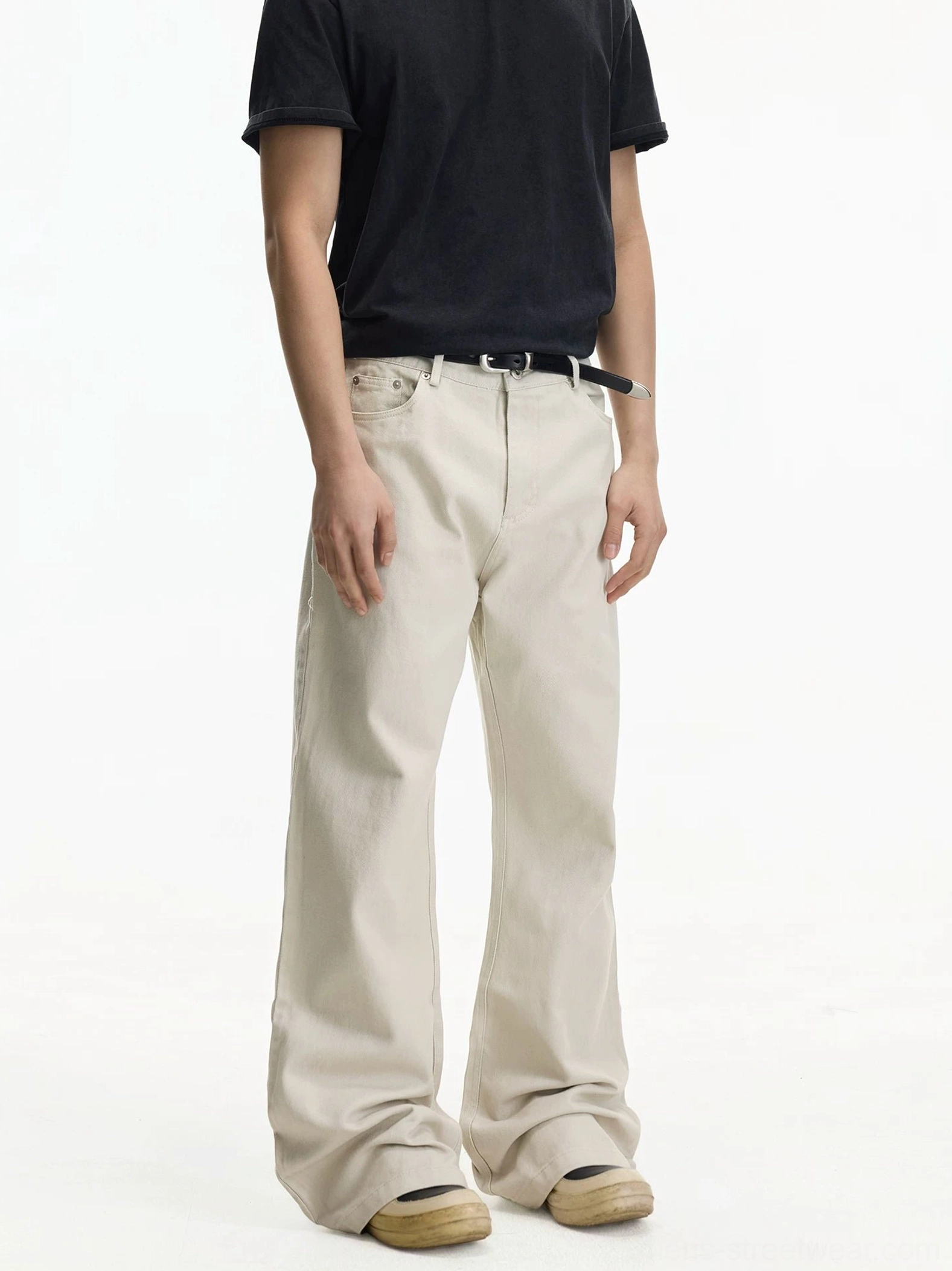 Off-white relaxed wide leg jeans front three-quarter view styled with black t-shirt and casual shoes
