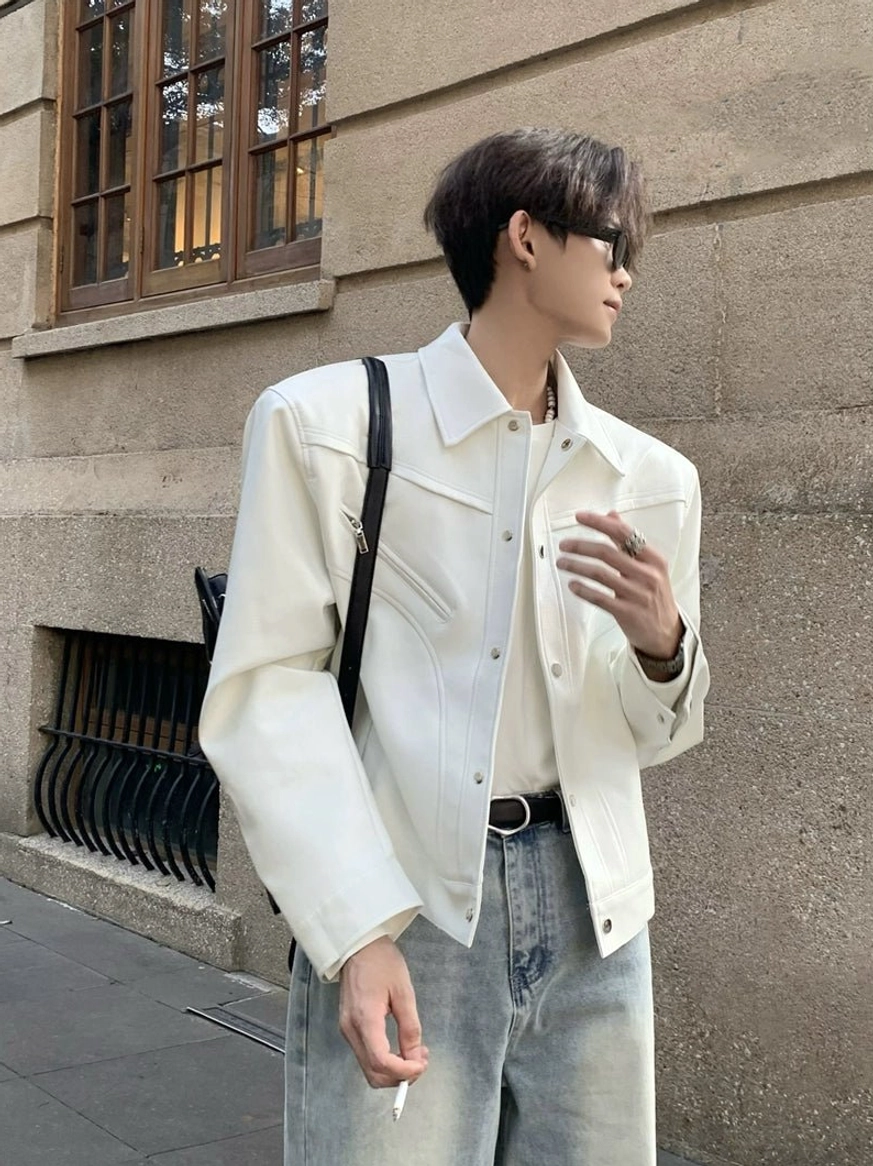 Off-white sculpted cropped denim jacket shown from the left three-quarter view with tailored seams and a clean urban streetwear outfit